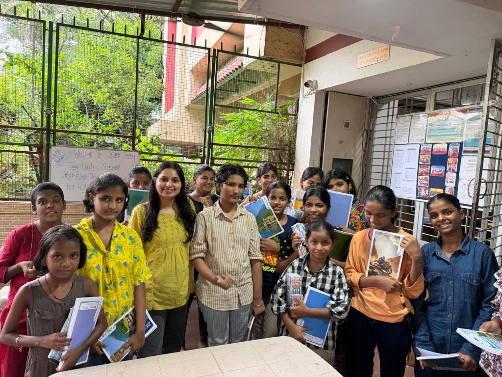 Children smiling after receiving books and stationery through MetaOptimus